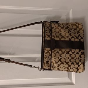 Brown, Coach handbag with center strip in the front.